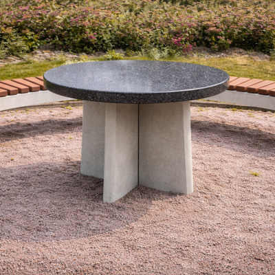 Round granite table in landscaped park